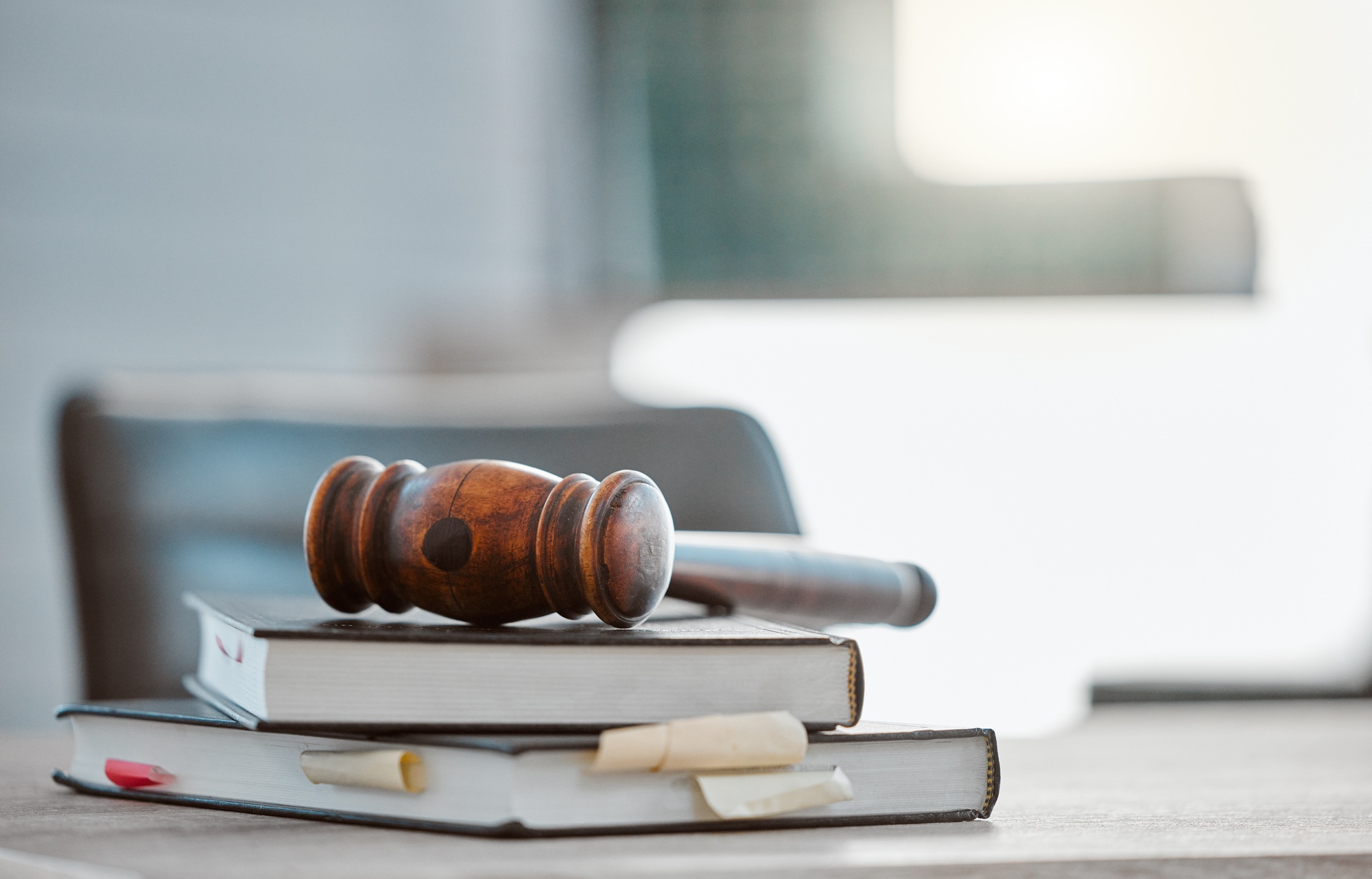 Justice, gavel and law books on table in office for court trial, legislation or fair constitution b